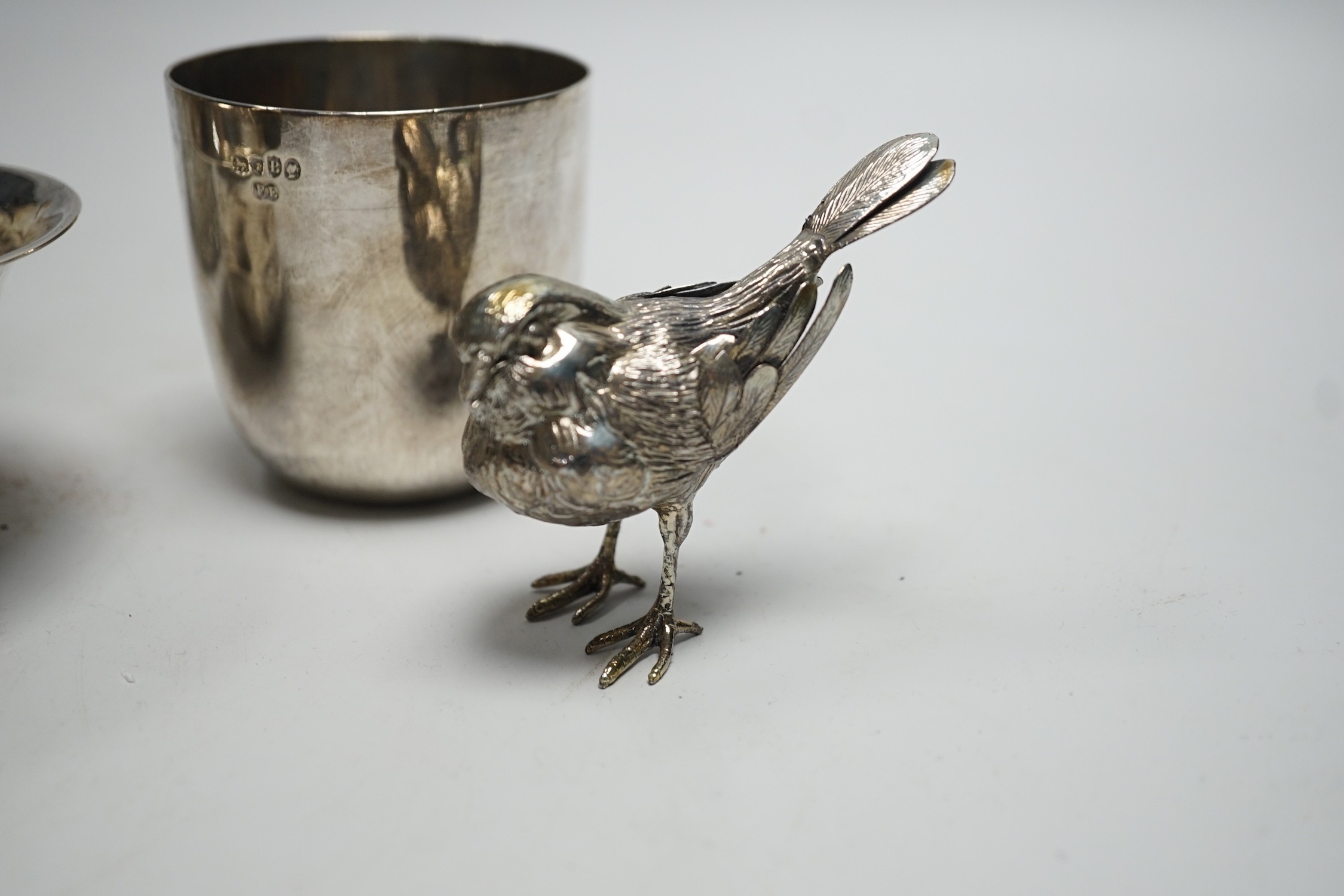 A Victorian silver tumbler cup, by Frederick Elkington, London, 1877, height 72mm, together with a silver mounted glass jar (lacking cover), a small silver bowl and an 800 white metal free-standing miniature model of a b